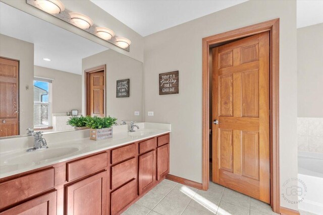 bathroom featuring vanity, a bathing tub, and tile patterned flooring