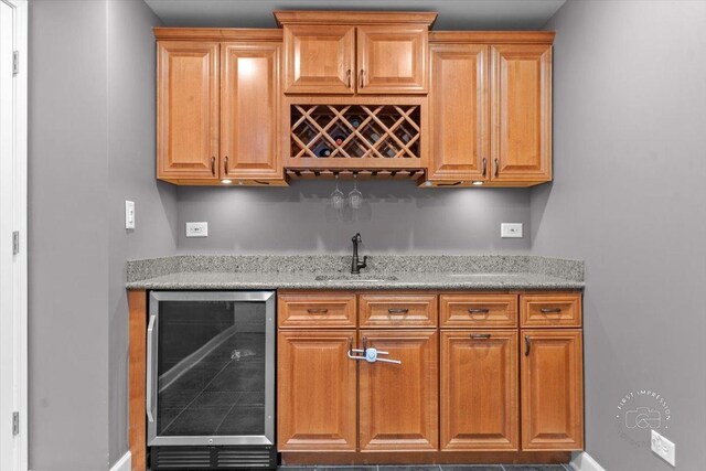 bar featuring sink and beverage cooler