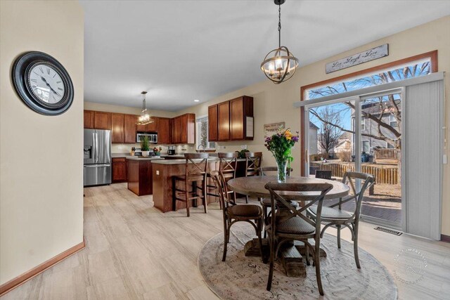 dining area with plenty of natural light and a chandelier