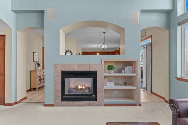 carpeted living room with a tiled fireplace