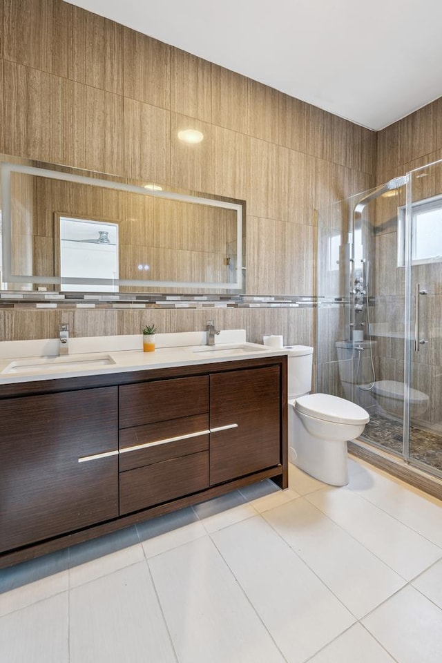 bathroom with toilet, an enclosed shower, tile patterned floors, and vanity