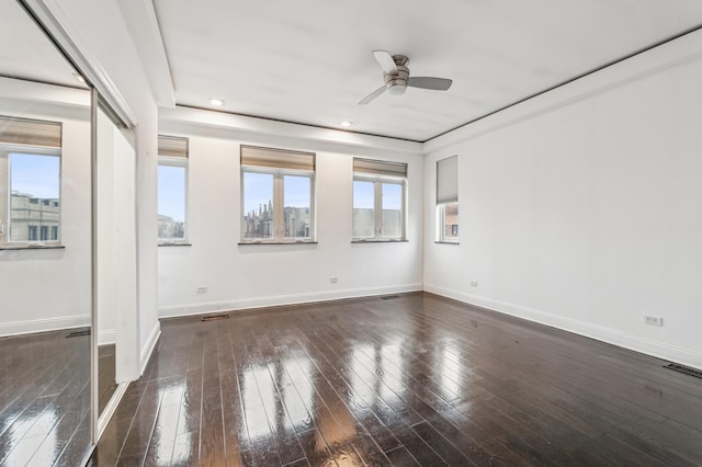 unfurnished room with ceiling fan and dark hardwood / wood-style flooring