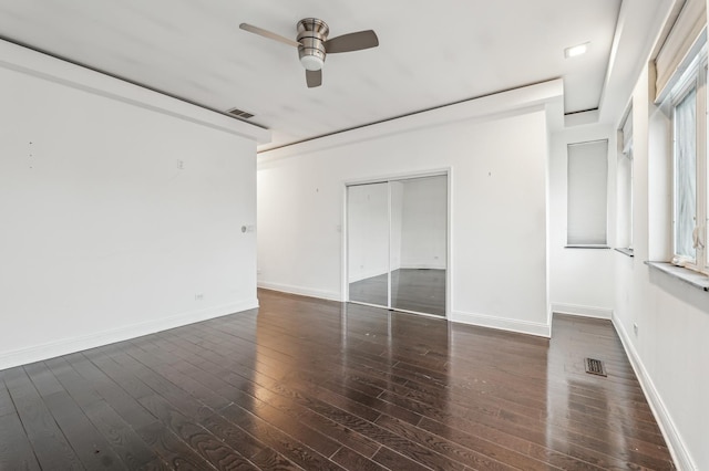 empty room featuring ceiling fan and dark hardwood / wood-style floors