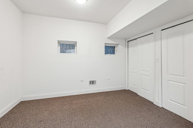 unfurnished bedroom with dark carpet