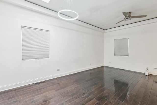 unfurnished room with dark hardwood / wood-style flooring and ceiling fan