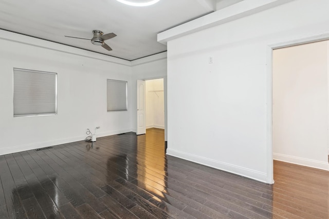 spare room featuring ceiling fan and dark hardwood / wood-style floors