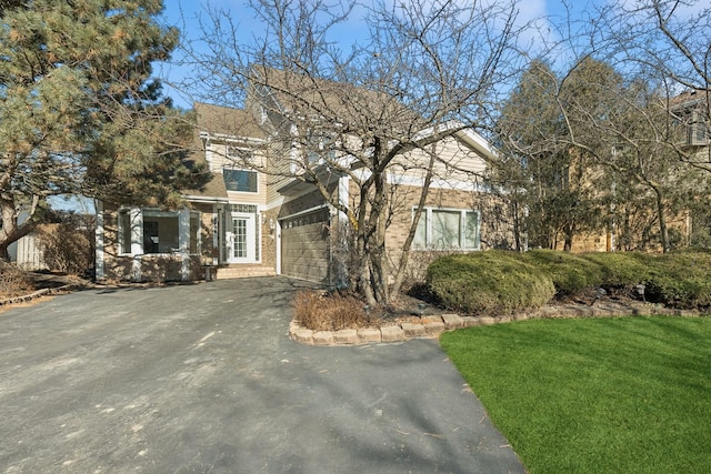 view of front facade with a garage and a front yard