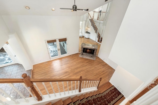 living room featuring a premium fireplace, ceiling fan, and hardwood / wood-style floors