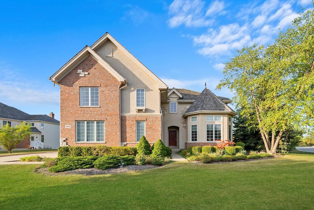 view of property featuring a front lawn