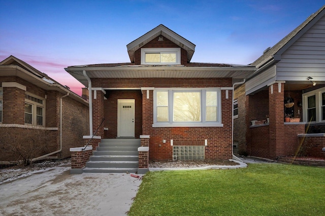 bungalow-style house with a lawn