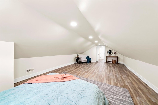 unfurnished bedroom with lofted ceiling and wood-type flooring