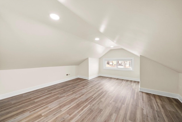 bonus room with wood-type flooring and lofted ceiling