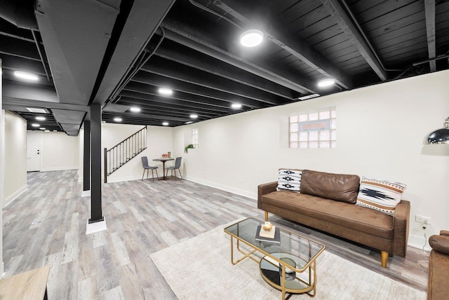 living room with beam ceiling and light hardwood / wood-style floors