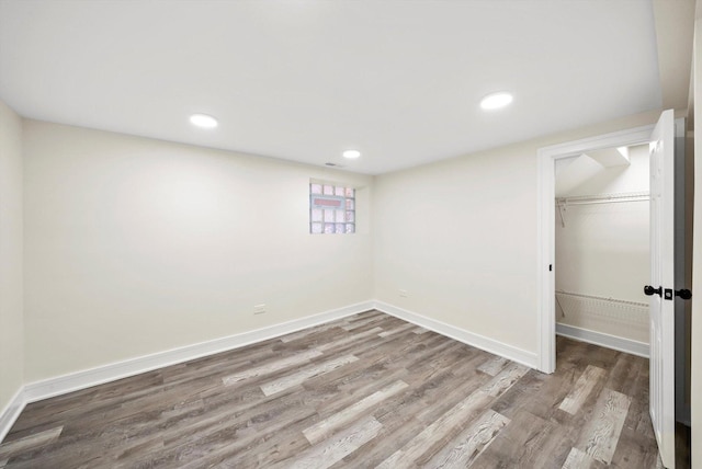 basement with hardwood / wood-style floors