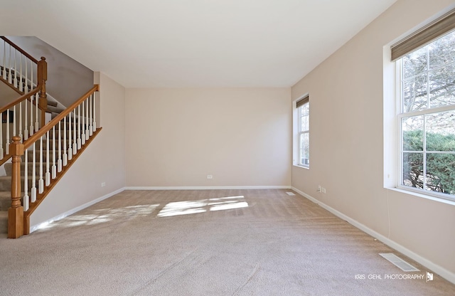 spare room with light carpet and a healthy amount of sunlight