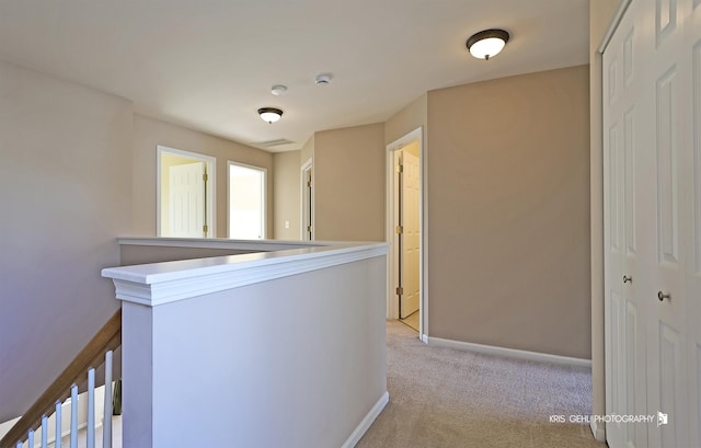 corridor featuring light colored carpet