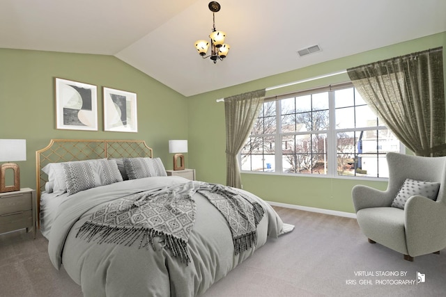 bedroom with carpet, vaulted ceiling, and a chandelier