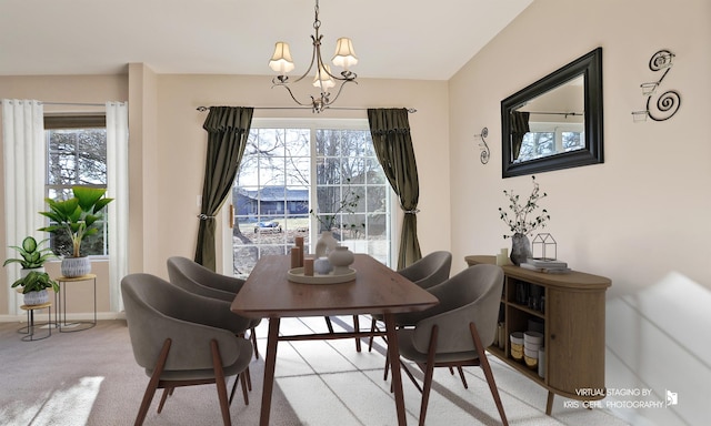 carpeted dining area with a notable chandelier