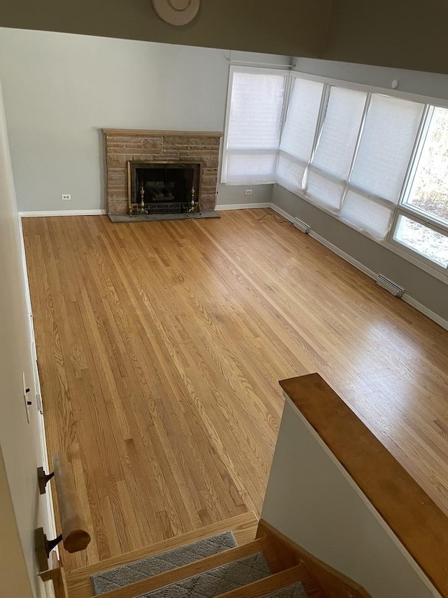 unfurnished living room featuring hardwood / wood-style floors and plenty of natural light