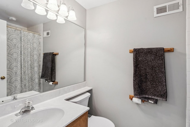 bathroom featuring toilet and vanity