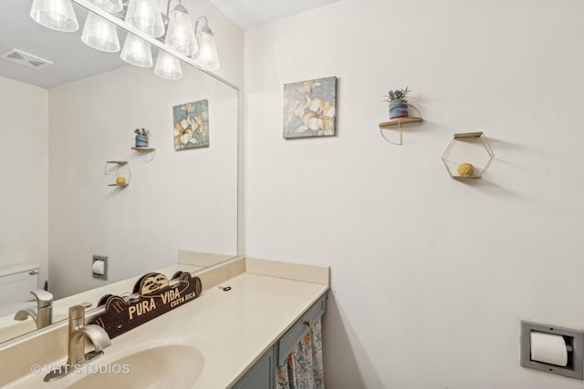 bathroom featuring toilet and vanity