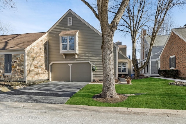 view of front property featuring a garage and a front lawn