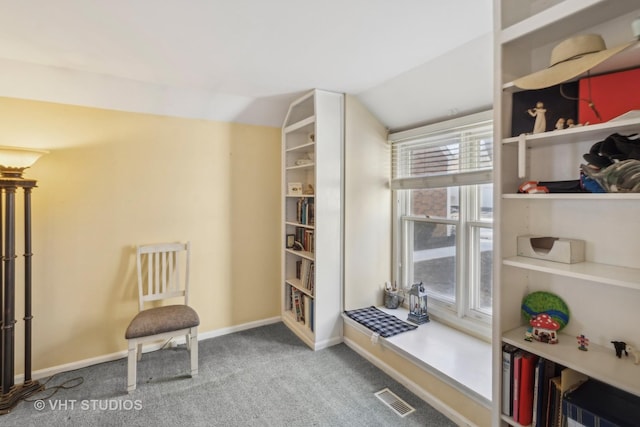 sitting room with vaulted ceiling and carpet flooring