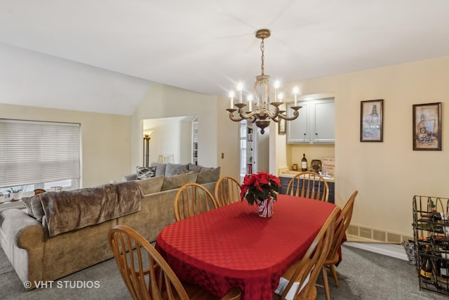 dining room with lofted ceiling, carpet floors, and a chandelier