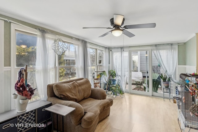 sunroom featuring ceiling fan and plenty of natural light