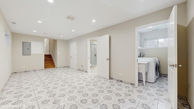 spare room featuring electric panel and washer and dryer