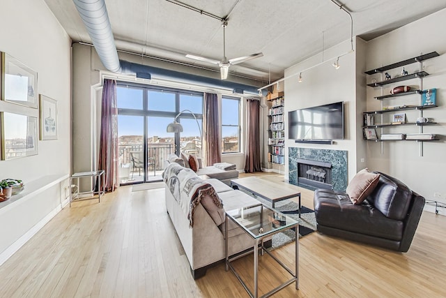 living room featuring light hardwood / wood-style flooring and a premium fireplace