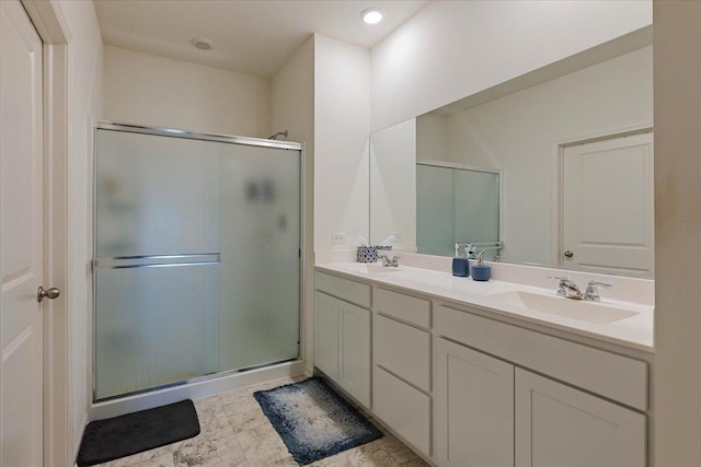 bathroom featuring walk in shower and vanity