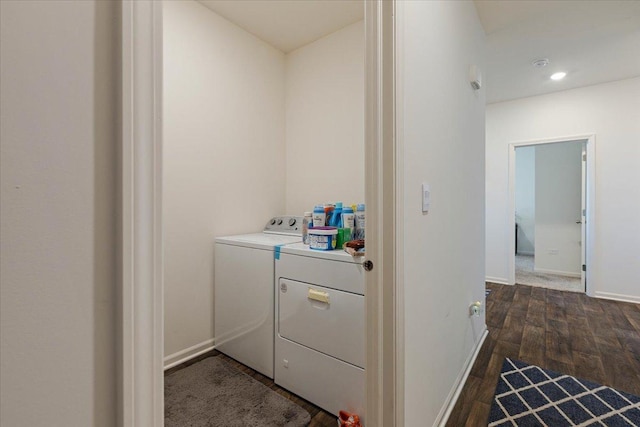 laundry room with washing machine and dryer and dark hardwood / wood-style floors