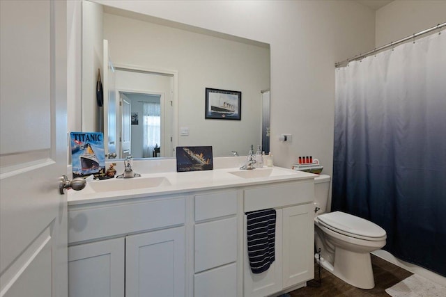 bathroom with toilet, hardwood / wood-style flooring, and vanity