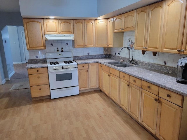 kitchen featuring light hardwood / wood-style floors, light brown cabinets, white range with gas cooktop, light stone countertops, and sink