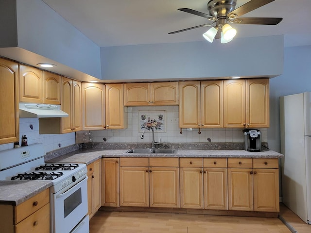 kitchen featuring white appliances, light brown cabinetry, sink, backsplash, and light wood-type flooring