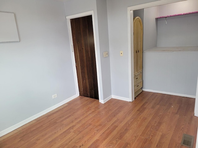 unfurnished bedroom featuring a closet and light hardwood / wood-style flooring