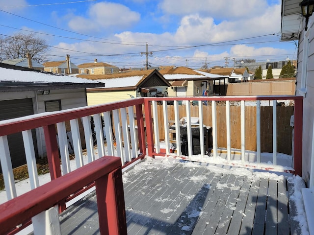 snow covered back of property featuring a grill