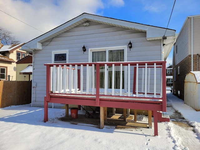 view of snow covered rear of property