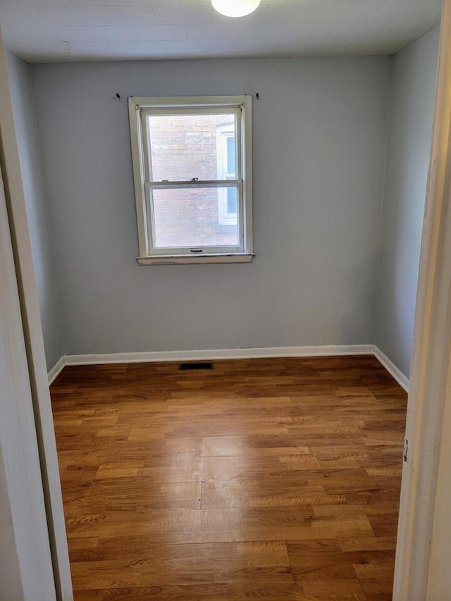 empty room featuring wood-type flooring