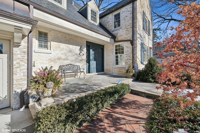 doorway to property with a patio area