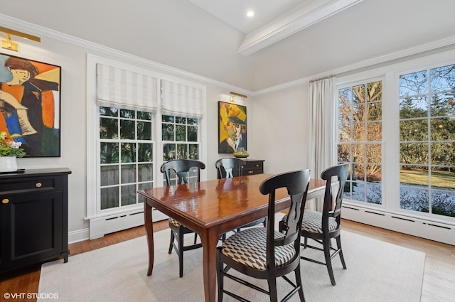 dining room featuring a baseboard heating unit, ornamental molding, light hardwood / wood-style flooring, and beamed ceiling