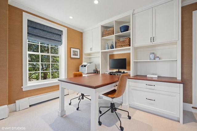 office space featuring light colored carpet, baseboard heating, and crown molding