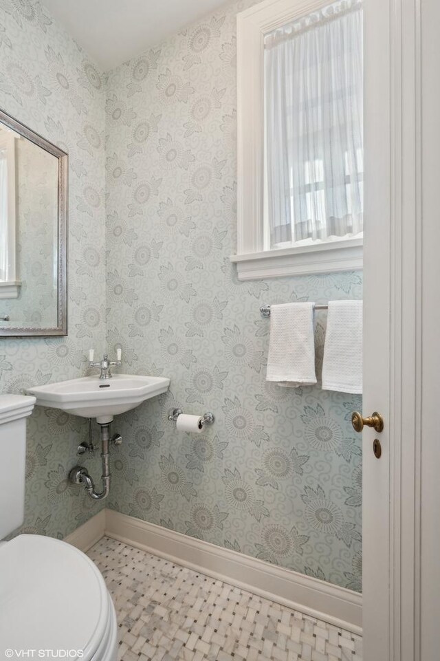 bathroom featuring toilet and tile patterned flooring