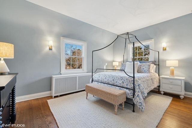 bedroom with radiator and dark hardwood / wood-style floors