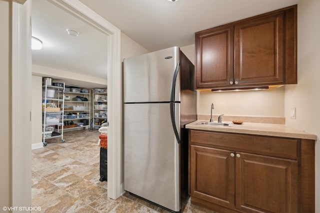 kitchen with sink and stainless steel refrigerator