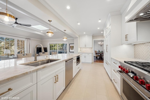 kitchen featuring white cabinetry, sink, stainless steel appliances, and custom range hood