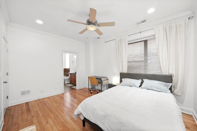 bedroom featuring ceiling fan, ensuite bathroom, ornamental molding, and light hardwood / wood-style flooring