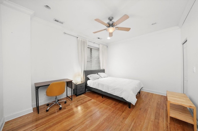 bedroom featuring ceiling fan, hardwood / wood-style floors, and ornamental molding