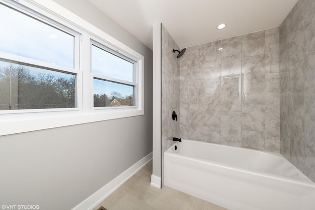 bathroom featuring tile patterned floors and tiled shower / bath combo